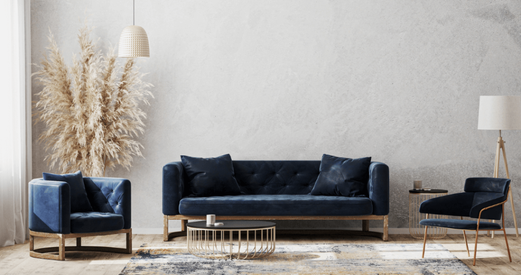 Imagen en la página de Muebles Cancún que muestra una sala de estar que destaca por su elegancia y refinamiento, donde sé ubican tres piezas de muebles azules con una excelente tapicería.